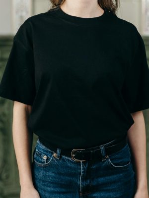 Casual fashion style featuring a black T-shirt paired with blue jeans, perfect for everyday wear.